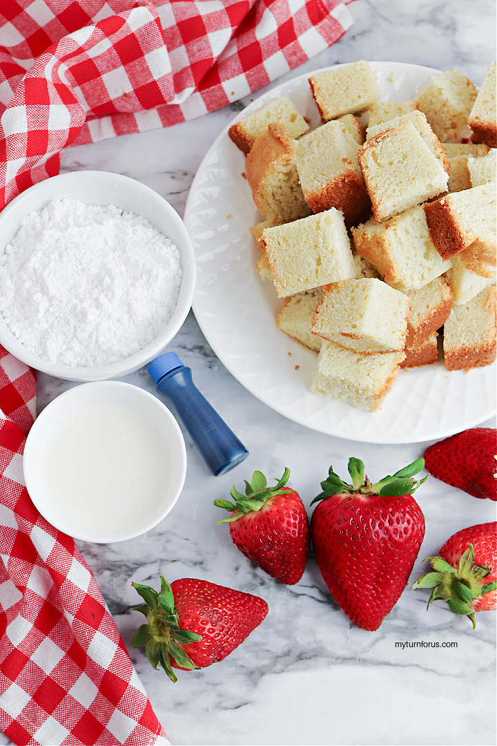cake cubes, strawberries and powdered sugar