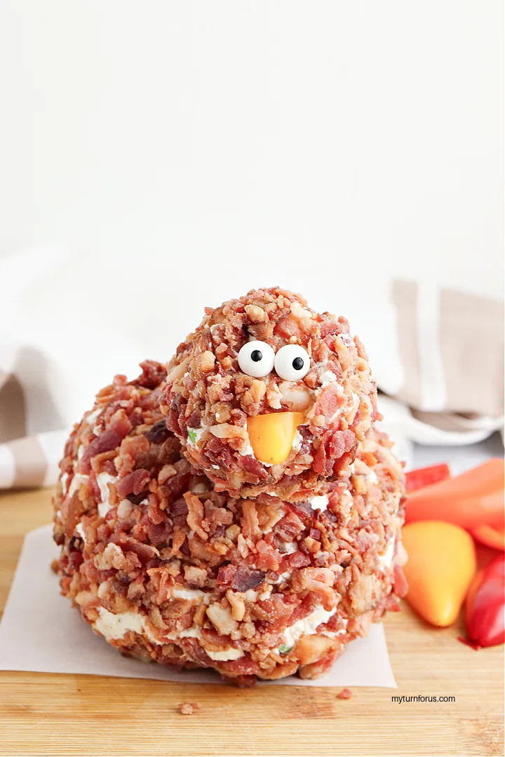 Adding beak and eyes to turkey cheese ball